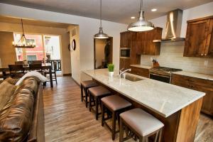 a kitchen with a large island with bar stools at Suite Retreat by Casago McCall - Donerightmanagement in McCall