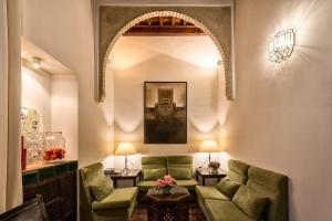 a living room filled with furniture and a large window at Hotel Casa Morisca in Granada