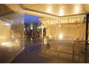 a swimming pool in a house with a pool at Tazawako Lake Resort & Onsen / Vacation STAY 78931 in Senboku +2 photos