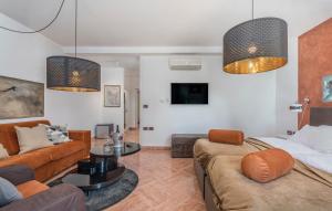 a living room with two couches and a tv at Rooms Porto in Savudrija