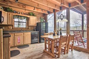 una cucina con tavolo in legno e frigorifero di Sevierville Sanctuary Hot Tub, Pool Table and Deck! a Sevierville