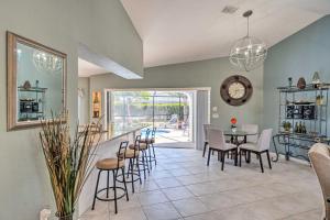 a kitchen and dining room with a table and chairs at Modern House Less Than 5 Miles to Port Charlotte Beach! in Port Charlotte
