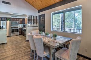 a kitchen and dining room with a table and chairs at Rustic-Chic Prescott Cabin with Deck in Wooded Area! in Prescott