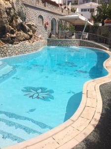 a large swimming pool with blue water at Hotel La Floridiana in Capri