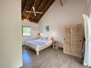 a bedroom with a bed and a wooden floor at Fare noanoa in Mariuti