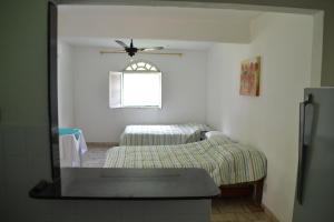 Cama ou camas em um quarto em Itaoca Pousada Camping
