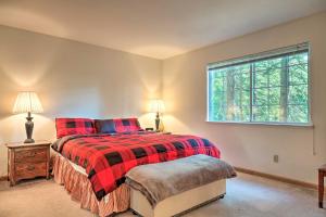 a bedroom with a red bed and a window at 4 Mi to Big Tree State Park Serene Cabin with Deck in Arnold