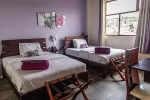 Ένα ή περισσότερα κρεβάτια σε δωμάτιο στο Hotel Colonial San Agustin