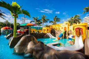 a water park at a resort with a water slide at Crown Paradise Club Cancun - All Inclusive in Cancún