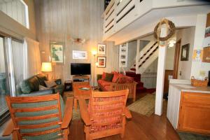 a living room with a couch and a table with chairs at SIerra Park Villas #06 in Mammoth Lakes