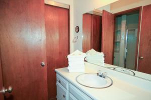 a bathroom with a sink and a mirror at SIerra Park Villas #06 in Mammoth Lakes +6 photos