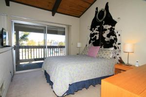 a bedroom with a bed and a large window at Sierra Park Villas #24 in Mammoth Lakes