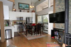 een keuken met een tafel en stoelen en een televisie bij Sierra Park Villas #03 in Mammoth Lakes