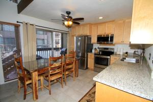 a kitchen with a table and chairs and a kitchen with a ceiling fan at Sierra Park Villas #82 in Mammoth Lakes