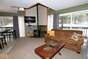 a living room with a couch and a table at Sierra Park Villas #65 in Mammoth Lakes