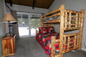 a bedroom with a wooden bunk bed in a room at Sierra Park Villas #65 in Mammoth Lakes