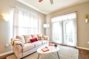 a living room with a couch and a table at Kasa Legacy Town Center Plano in Plano