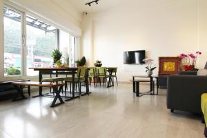 a living room with a table and chairs at Haichin&Haiting B&B in Donggang