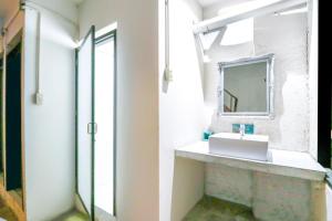 a bathroom with a sink and a mirror at OYO 688 Bangkok Hub Hostel in Bangkok