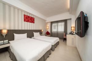 Voodi või voodid majutusasutuse Fish Hotel Hualien toas