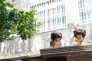 two heads on the side of a building at My Way House 好巷一弄民宿 in Tainan