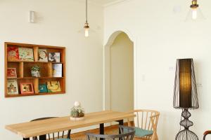 a dining room with a wooden table and chairs at My Way House 好巷一弄民宿 in Tainan +60 photos