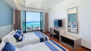 Letto o letti in una camera di Arena Beach Hotel