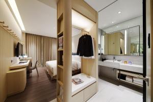 Ένα ή περισσότερα κρεβάτια σε δωμάτιο στο Jasper Young Hotel Banqiao