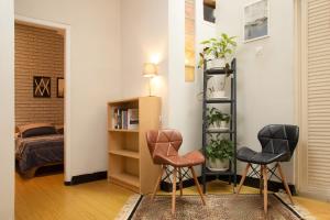two chairs and a book shelf in a room at Huning House - 5 Bedrooms in Purwokerto