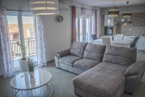 a living room with a couch and a table at Apartments Villa Lili in Crikvenica