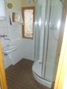 a bathroom with a shower and a sink at Kemp Rumcajs in Jičín