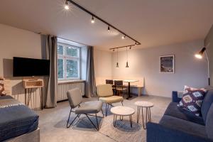a living room with a couch and a table at Belmont- Apartment Haus in Arosa