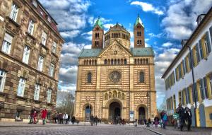 a tall building with two towers on top of it at Hotel Postgalerie Speyer in Speyer