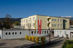a building with a flag in front of it at Jugend- und Familiengästehaus Villach in Villach