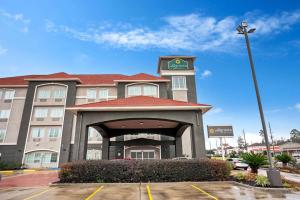 a hotel building with a clock on top of it at La Quinta by Wyndham Houston - Magnolia in The Woodlands