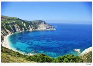 an aerial view of a beach with blue water at Petani Bay Hotel - Adults Only in Vóvikes