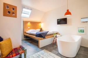a bathroom with a bed and a tub in a room at Bunk Hotel Amsterdam in Amsterdam