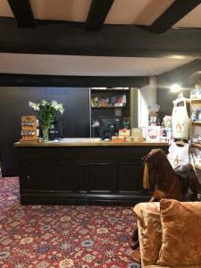 a salon with a counter and a chair in a room at The Dog & Partridge Country Inn in Ashbourne