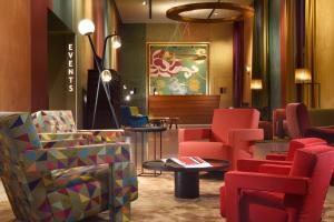 ミラノにあるエンタープライズ ホテル デザイン ＆ ブティックのロビー(椅子、テーブル、絵画付)