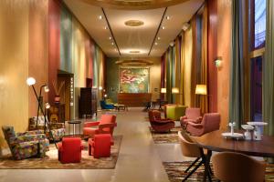 a lobby with colorful chairs and tables in a building at Enterprise Hotel Design & Boutique in Milan