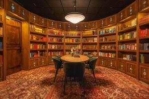 a large room with a large bookcase and many books at BUNK Hotel Amsterdam in Amsterdam