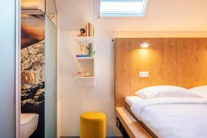 a bedroom with a bed and a window at BUNK Hotel Amsterdam in Amsterdam