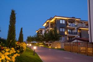 a building with lights on the side of a street at Nevis Resort & Aqua Park - All Inclusive in Sunny Beach