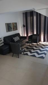 a living room with a couch and a rug at Amazing in Haifa