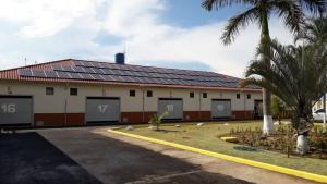 a building with a lot of solar panels on it at SP Hotel & Motel in Mogi Mirim