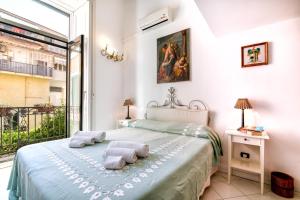 a bedroom with a bed and a large window at Amalfi Centre Flats in Amalfi