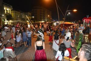 a large crowd of people standing on a street at night at Apartamento Urb. Vila Nova, Lote 5 in Armação de Pêra +40 photos