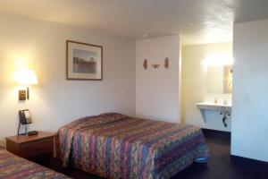a hotel room with a bed and a sink at Tombstone Motel in Tombstone