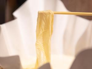 a wooden chopstick holding a piece of paper at APA Hotel Kyoto Eki Horikawadori in Kyoto