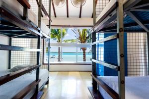 a room with two bunk beds and a view of the ocean at The Yak Lake House - Hostal in Bacalar